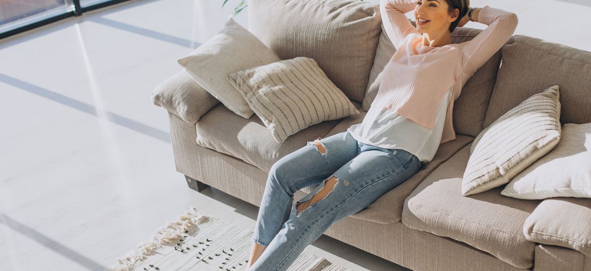 Women on couch enjoying good home ventilation